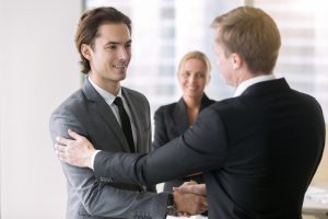 Manager congratulating his associate