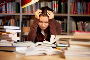 stressed girl studying in the library